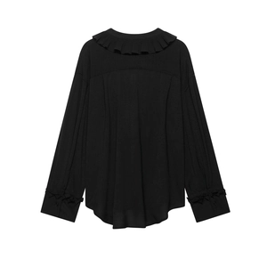 Detail view of the back of a black chiffon blouse featuring pleated ruffles and a curved hemline