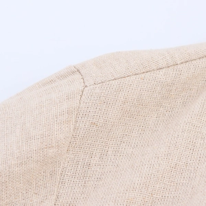 Close-up of beige linen shirt dress showing high-quality woven fabric and seam stitching