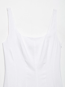 Close-up of square neckline and textured fabric stitching on white midi dress