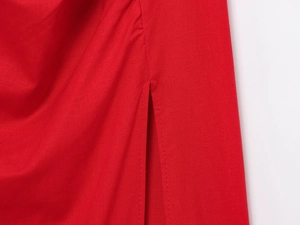 Detailed close-up of red textile fabric with stylish slit design and ruching texture