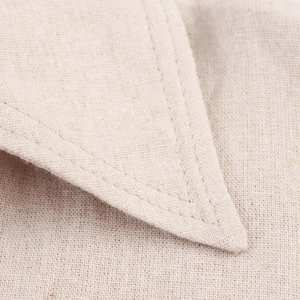 Macro detail of the lapel corner showing double-stitched cotton linen fabric texture