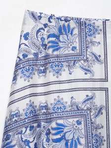 Detailed close-up of blue and white paisley floral print on lightweight fabric