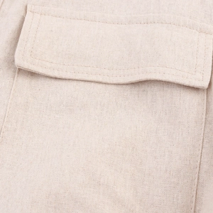Close-up of the beige cotton linen shirt dress flap pocket with reinforced double stitching
