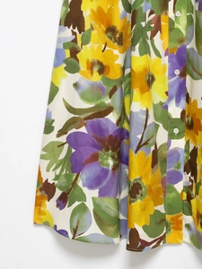 Close-up of floral print V-neck dress featuring yellow sunflowers and white buttons