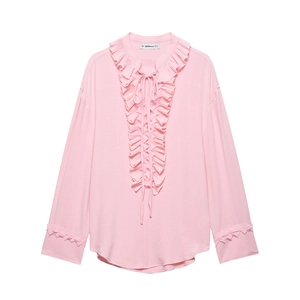 Close-up of pink blouse with layered ruffles, drawstring neckline and pleated cuffs