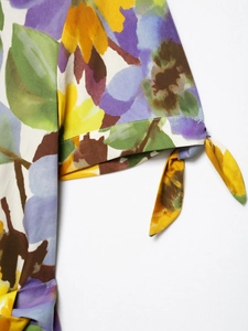 Detailed close-up of floral print short sleeve with decorative self-tie knot design