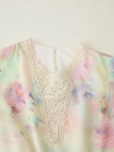 Close-up of V-neck tie-dye chiffon dress with white lace trim and back button detail