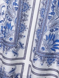 Close-up of blue paisley print and linen texture on elegant bohemian maxi skirt