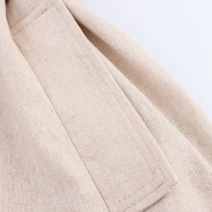 Close-up of beige cotton linen fabric with high-quality double-needle stitching detail