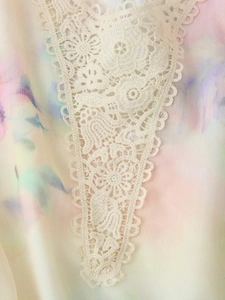 Detailed close-up of white floral lace applique on macaron tie-dye chiffon summer dress