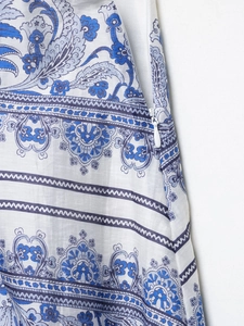 Detail of elegant paisley print long skirt featuring a white invisible side zipper