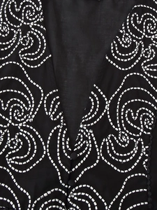 Close-up of black V-neck top featuring white chain-stitch embroidery and small covered buttons