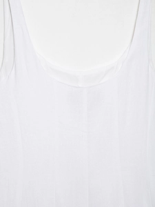 Close-up of white midi dress bodice featuring round neck and vertical stitching detail