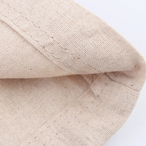 Detailed macro view of beige cotton linen fabric with durable double-stitch sewing