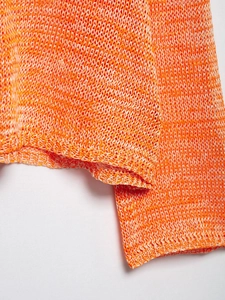 Detailed macro view of orange-white mixed knit hollow-out crochet mesh texture and hem