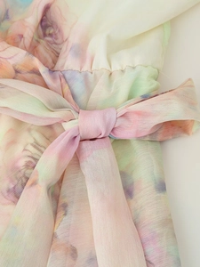 Detail of floral watercolor print dress with chiffon texture and waist tie bow