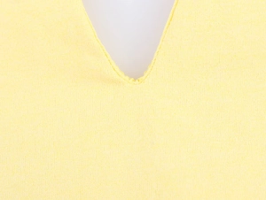 Close-up of the elegant V-neckline on a bright yellow sleeveless maxi dress