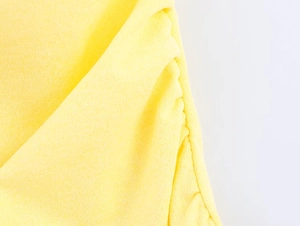 Detailed macro shot of the yellow knitted fabric with elegant ruched design texture