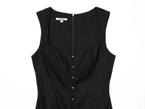 Detail of square neckline with brown buttons and back zipper on black linen dress