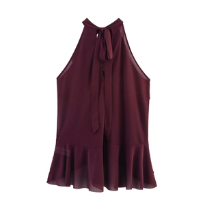 Detail of burgundy halter neck chiffon top featuring a bow tie and ruffled hem design