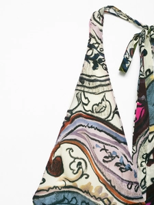 Detailed close-up of paisley and floral prints on a halter neck summer dress fabric