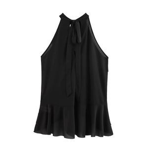 Detail of a black halter top featuring a back bow tie and tiered ruffle hem design