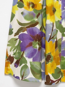 Detailed view of vibrant floral print fabric with high-quality stitching and button detail
