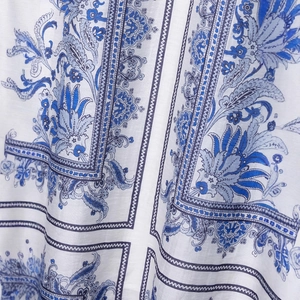 Elegant white floral print maxi skirt with vintage blue ethnic patterns and textured fabric