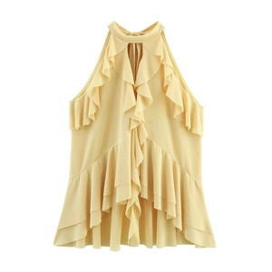 Detailed view of yellow halter top featuring ruffled layers and front cutout design