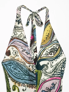 Detailed view of bohemian paisley print and halter neck tie on floral summer dress