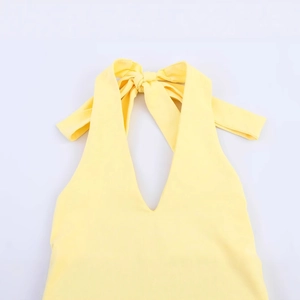Elegant bright yellow halter neck dress with deep V-neck and bow tie detail
