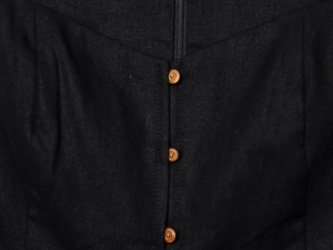 Detail of a black linen midi dress featuring natural wood buttons and a sweetheart neckline