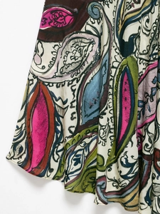 Close-up of vibrant paisley pattern on bohemian chiffon dress with intricate floral details