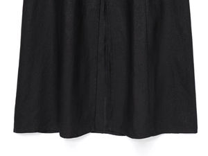 Close-up of black linen midi dress hem showing premium fabric texture and neat stitching