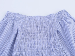 Detail of blue and white striped off-shoulder top with elastic smocked bodice texture