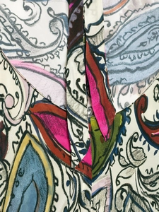 Close-up of vibrant paisley print on women's summer dress with detailed stitching