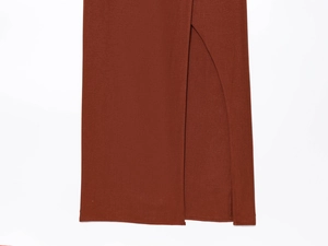 Detailed close-up of side slit design on a caramel linen texture fashion dress