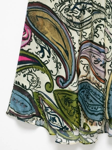 Detailed close-up of colorful Paisley pattern print on lightweight summer dress hemline