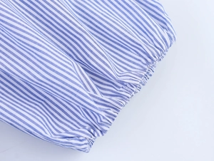 Close-up of elastic ruffled cuffs on a blue and white striped cotton summer dress