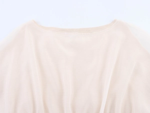 Detail of light beige chiffon knit top showing elegant round neckline and fabric texture