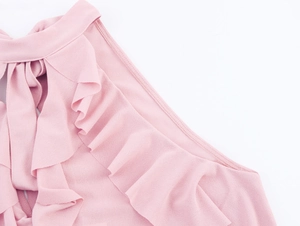 Close-up of pink halter neck top featuring tiered ruffles and chiffon fabric texture