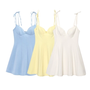Detailed flat lay of mini bow strap dresses in light blue, yellow, and cream white colors