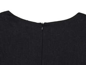 Close-up of seamless invisible zipper detail on the back of a black linen midi dress