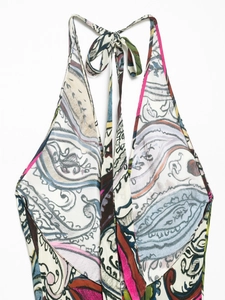 Detail of elegant paisley print halter neck dress featuring deep V-neckline and colorful pattern