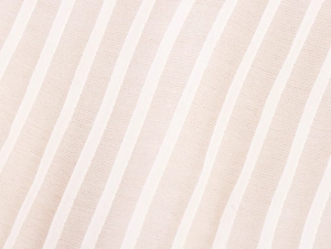 Macro view of light pink striped sheer knit fabric with delicate textured weave details