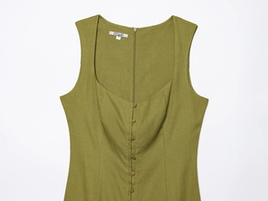 Detail view of grass green linen dress with retro square neckline and wooden buttons