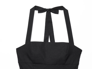 Detail of black halter neckline with back tie-up bow on a summer mini dress