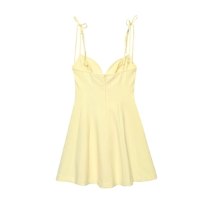 Close-up of butter yellow mini dress with adjustable spaghetti straps and V-neckline