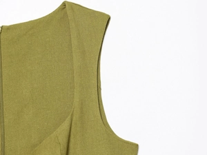 Detail view of olive green linen dress fabric texture and side invisible zipper closure