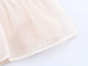 Detail of sheer pleated organza fabric with fine stitching for women's blouse top